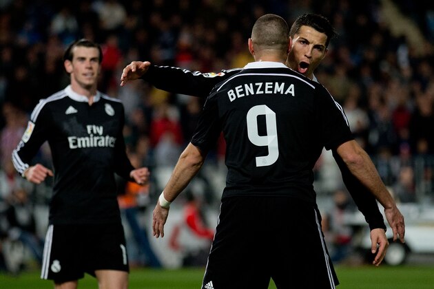ALMERIA, SPAIN - DECEMBER 12:  Cristiano Ronaldo (R) of Real Madrid CF celebrates scoring their third goal with teammate Karim Benzema (L) as Gareth Bale (L) runs to them during the La Liga match between UD Almeria and Real Madrid CF at Juegos del Mediterraneo stadium on December 12, 2014 in Almeria, Spain.  (Photo by Gonzalo Arroyo Moreno/Getty Images)