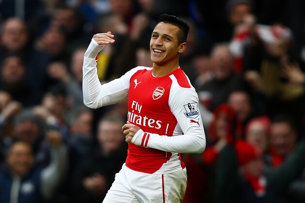 LONDON, ENGLAND - JANUARY 11:  Alexis Sanchez of Arsenal celebrates after scoring his team's third goal during the Barclays Premier League match between Arsenal and Stoke City at Emirates Stadium on January 11, 2015 in London, England.  (Photo by Clive Rose/Getty Images)