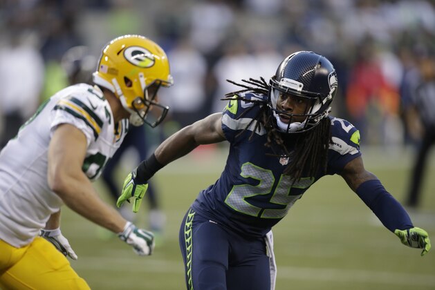 Seattle Seahawks cornerback Richard Sherman (25) begins pass coverage against the Green Bay Packers in the second half of an NFL football game, Thursday, Sept. 4, 2014, in Seattle. (AP Photo/Stephen Brashear)