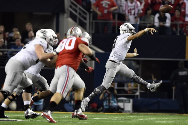Jan 12, 2015; Arlington, TX, USA; Oregon Ducks quarterback Marcus Mariota (8) throws a pass during the second quarter against the Ohio State Buckeyes in the 2015 CFP National Championship Game at AT&T Stadium. Mandatory Credit: Tommy Gilligan-USA TODAY Sports