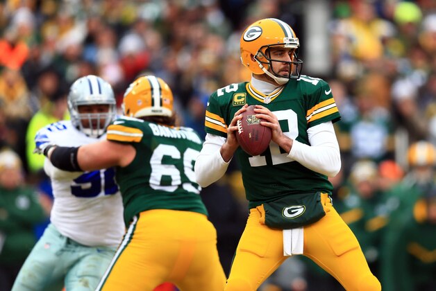 Jan 11, 2015; Green Bay, WI, USA; Green Bay Packers quarterback Aaron Rodgers throws a pass against the Dallas Cowboys in the first half in the 2014 NFC Divisional playoff football game at Lambeau Field. Mandatory Credit: Andrew Weber-USA TODAY Sports