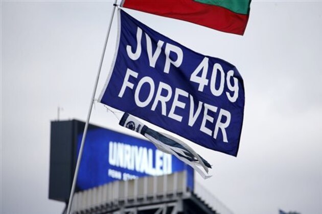 A banner celebrating the 409 wins of former Penn State football coach Joe Paterno waves over the parking lot tailgating outside Beaver Stadium before  an NCAA college football game between the Penn State and the Temple in State College, Pa., Saturday, Nov. 15, 2014. (AP Photo/Gene J. Puskar)