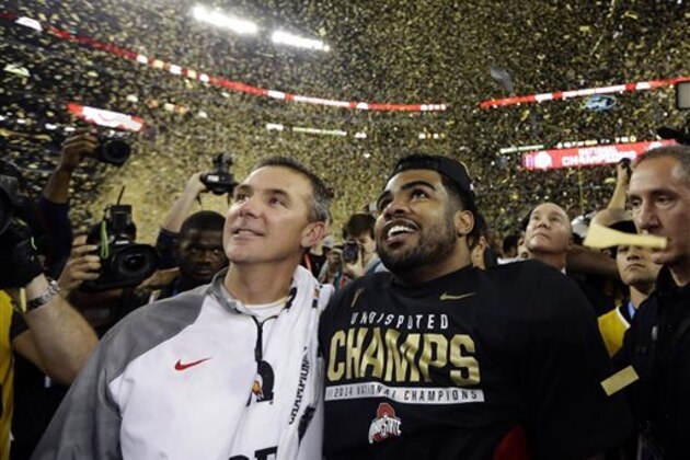 CORRECTS PLAYER AT RIGHT  TO EZEKIEL ELLIOTT- Ohio State head coach Urban Meyer and Ezekiel Elliott celebrate after the NCAA college football playoff championship game against Oregon Monday, Jan. 12, 2015, in Arlington, Texas. Ohio State won 42-20. (AP Photo/David J. Phillip)