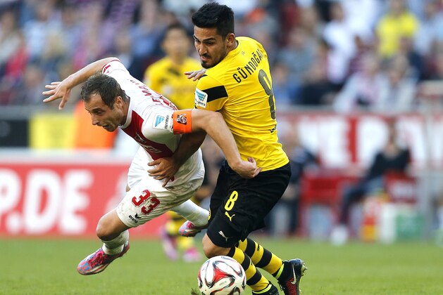 Cologne's Matthias Lehmann, left, and Dortmund's Ilkay Gundogan challenge for the ball during the German first division Bundesliga soccer match between 1.FC Cologne and BvB Borussia Dortmund in Cologne, Germany, Saturday, Oct. 18, 2014. (AP Photo/Frank Augstein)