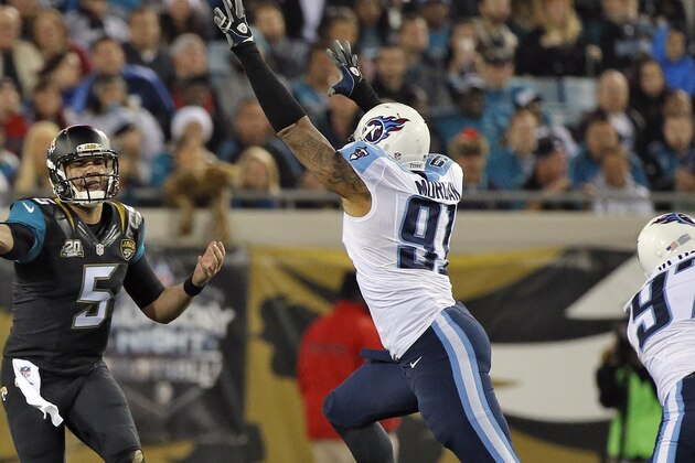 Jacksonville Jaguars quarterback Blake Bortles (5) throws a pass as he is pressured by Tennessee Titans outside linebacker Derrick Morgan (91) during the third quarter of an NFL football game Thursday, Dec. 18, 2014, in Jacksonville, Fla. (AP Photo/Stephen B. Morton)