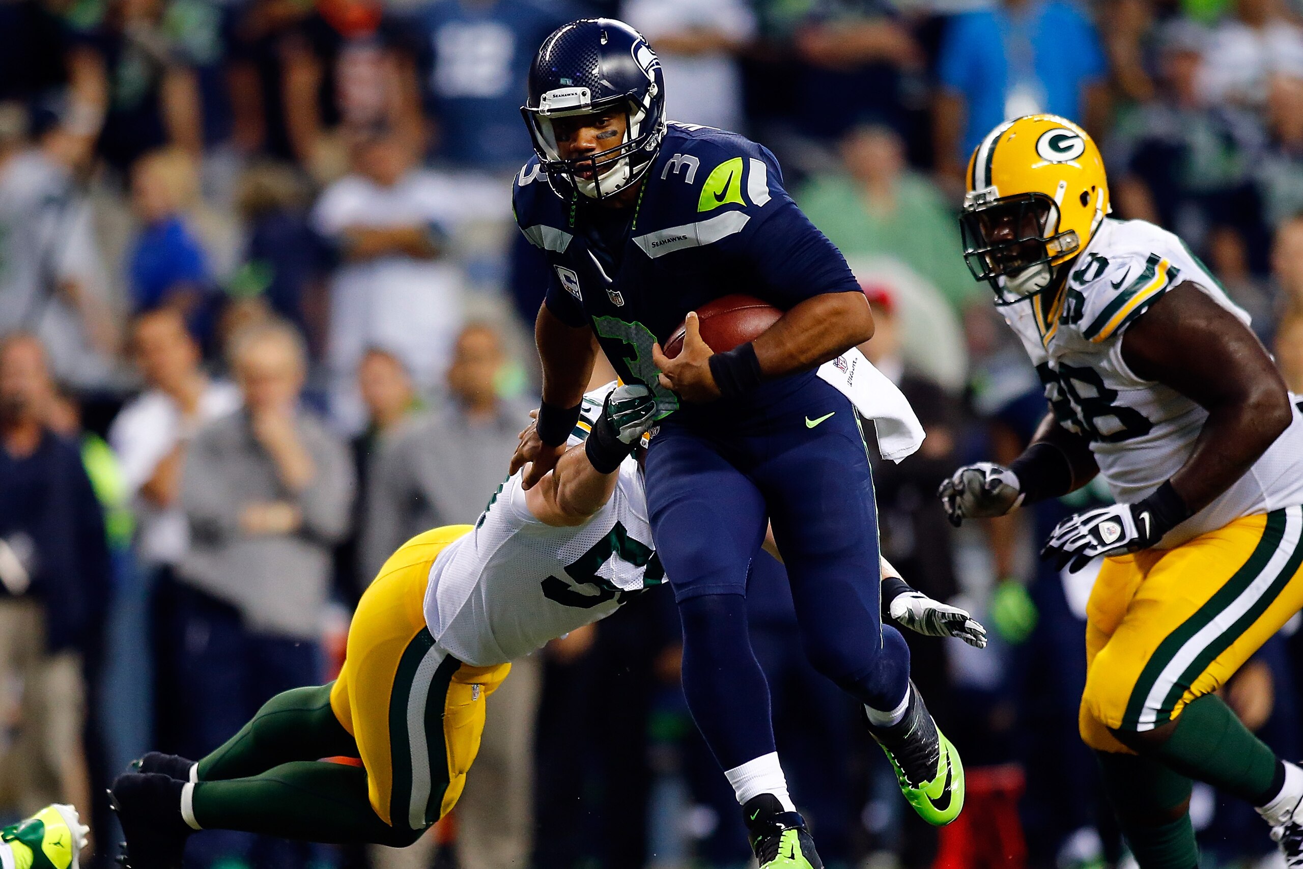 SEATTLE, WA - SEPTEMBER 04: Quarterback Russell Wilson #3 of the Seattle Seahawks runs with the ball during the fourth quarter of the game against the Green Bay Packers at CenturyLink Field on September 4, 2014 in Seattle, Washington.  (Photo by Jonathan Ferrey/Getty Images)