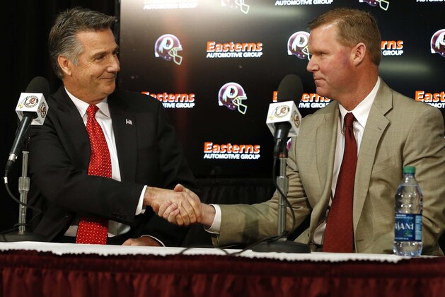Jan 9, 2015; Ashburn, VA, USA; Washington Redskins president Bruce Allen (left) shakes hands with Washington Redskins new general manager Scot McCloughan (right) at McCloughan's introductory press conference at Redskins Park. Mandatory Credit: Geoff Burke-USA TODAY Sports