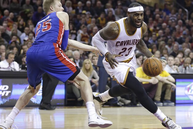 Cleveland Cavaliers' LeBron James (23) drives around Detroit Pistons’ Kyle Singler (25) during an NBA basketball game Sunday, Dec. 28, 2014, in Cleveland. (AP Photo/Tony Dejak)