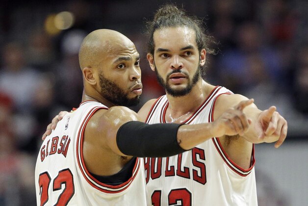 Chicago Bulls forward Taj Gibson (22) and forward Joakim Noah (13) point during the second half of an NBA basketball game against the Boston Celtics in Chicago on Saturday, Jan. 3, 2015. The Bulls won in overtime 109-104.  (AP Photo/Nam Y. Huh)
