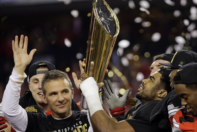 Ohio State head coach Urban Meyer and Ezekiel Elliott celebrate after the NCAA college football playoff championship game against Oregon Monday, Jan. 12, 2015, in Arlington, Texas. Ohio State won 42-20. (AP Photo/Eric Gay)
