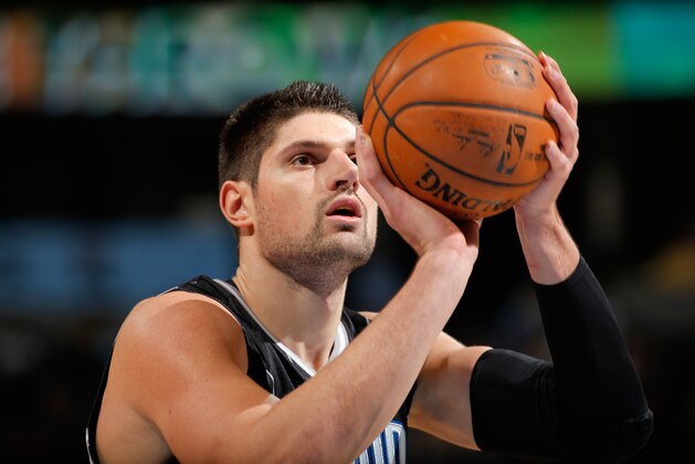 DENVER, CO - JANUARY 07:  Nikola Vucevic #9 of the Orlando Magic takes a free throw against the Denver Nuggets at Pepsi Center on January 7, 2015 in Denver, Colorado. The Nuggets defeated the Magic 93-90. NOTE TO USER: User expressly acknowledges and agrees that, by downloading and or using this photograph, User is consenting to the terms and conditions of the Getty Images License Agreement.  (Photo by Doug Pensinger/Getty Images)