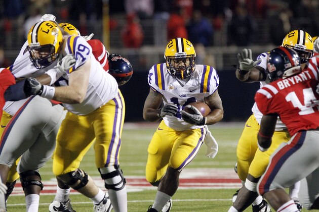 LSU running back Terrence Magee (14) rushes against Mississippi in the fourth quarter of an NCAA college football game in Oxford, Miss., on Saturday, Nov. 19,  2011. LSU won 52-3. (AP Photo/Rogelio V. Solis)
