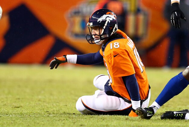 Jan 11, 2015; Denver, CO, USA; Denver Broncos quarterback Peyton Manning reacts as he sits on the ground after being sacked in the second half against the Indianapolis Colts in the 2014 AFC Divisional playoff football game at Sports Authority Field at Mile High. The Colts defeated the Broncos 24-13. Mandatory Credit: Mark J. Rebilas-USA TODAY Sports