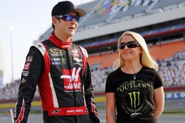 FILE - In this May 22, 2014, file photo, Kurt Busch, left, walks with Patricia Driscoll before qualifying for a NASCAR Sprint Cup series auto race at Charlotte Motor Speedway in Concord, N.C. The police investigation into allegations that NASCAR driver Kurt Busch assaulted his ex-girlfriend has been finished and forwarded to Delaware state prosecutors to decide whether charges will be filed. Cpl. Mark Hoffman with the Dover Police Department said Tuesday, Jan. 6, 2015,  that the agency's investigation into the allegations was finished, but he declined to say whether investigators were recommending that Busch be charged.  (AP Photo/Terry Renna)