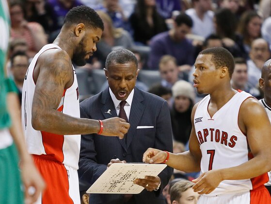 Jan 10, 2015; Toronto, Ontario, CAN; Toronto Raptors forward Amir Johnson (left) and head coach Dwane Casey and Toronto Raptors guard Kyle Lowry (right) discuss a play against the Boston Celtics at the Air Canada Centre. Toronto defeated Boston 109-96. Mandatory Credit: John E. Sokolowski-USA TODAY Sports