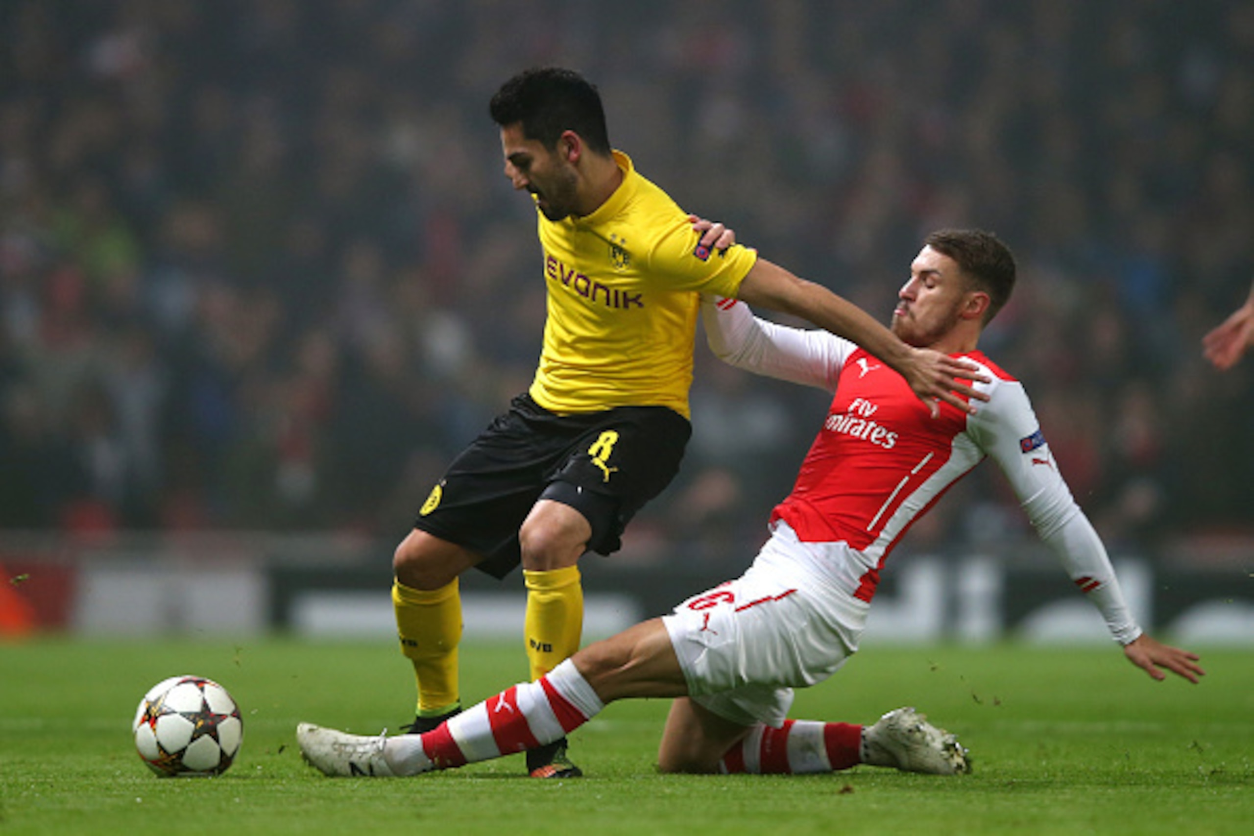LONDON, ENGLAND - NOVEMBER 26:  Ilkay Gundogan of Borussia Dortmund is tackled by Aaron Ramsey of Arsenal during the UEFA Champions League Group D match between Arsenal and Borussia Dortmund at the Emirates Stadium on November 26, 2014 in London, United Kingdom.  (Photo by Clive Rose/Getty Images)