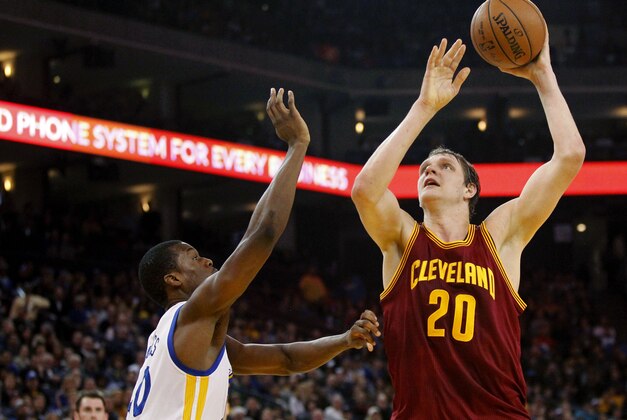 Jan 9, 2015; Oakland, CA, USA; Cleveland Cavaliers center Timofey Mozgov (20) attempts a shot over Golden State Warriors forward Harrison Barnes (40) in the second quarter at Oracle Arena. Mandatory Credit: Cary Edmondson-USA TODAY Sports