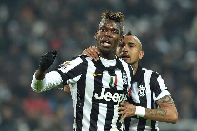 TURIN, ITALY - JANUARY 06:  Paul Pogba (L) of Juventus FC reacts during the Serie A match between Juventus FC and FC Internazionale Milano at Juventus Arena on January 6, 2015 in Turin, Italy.  (Photo by Valerio Pennicino/Getty Images)