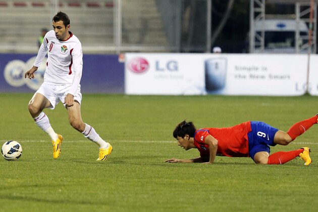 AMMAN, JORDAN - NOVEMBER 14: Ahmad Hayel of Jordan takes the ball from South Korean player Youngcheol Cho during an International Friendly match between Jordan and South Korea at King Abdullah Stadium on November 14, 2014 in Amman, Jordan. (Photo by Salah Malkawi/ Getty Images)
