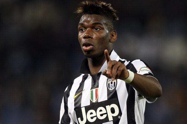 Juventus midfielder Paul Pogba gestures during the Italian Super Cup final match Napoli against Juventus in Doha, Qatar, Monday Dec. 22, 2014. (AP Photo/Osama Faisal)