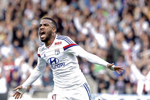 Lyon's Alexandre Lacazette celebrates after he scored his first goal against Lille during their French League One soccer match in Lyon, central France, Sunday, Oct. 5, 2014. (AP Photo/Laurent Cipriani)