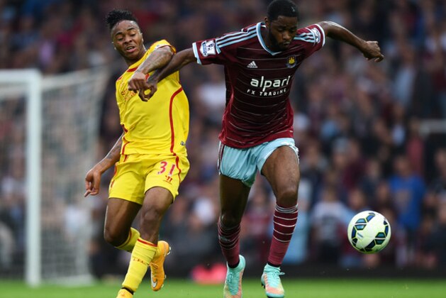 Liverpool’s Raheem Sterling, left, competes for the ball with West Ham United’s Alex Song during their English Premier League soccer match at Upton Park, London, Saturday, Sept. 20, 2014. (AP Photo/Tim Ireland)