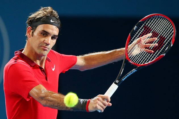 BRISBANE, AUSTRALIA - JANUARY 08:  Roger Federer of Switzerland plays a backhand in his match against John Millman of Australia during day five of the 2015 Brisbane International at Pat Rafter Arena on January 8, 2015 in Brisbane, Australia.  (Photo by Chris Hyde/Getty Images)
