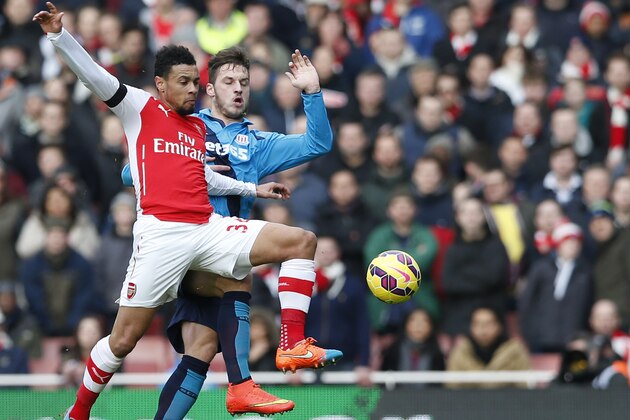 Arsenal's Francis Coquelin, left challenges Stoke City’s Marko Arnautovic for the ball during their English Premier League soccer match between Arsenal and Stoke City at the Emirates  stadium in London, Sunday, Jan. 11,  2015. (AP Photo/Alastair Grant)