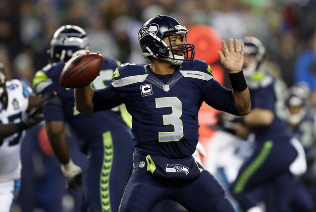 January 10, 2015; Seattle, WA, USA; Seattle Seahawks quarterback Russell Wilson (3) throws against the Carolina Panthers during the first half in the 2014 NFC Divisional playoff football game at CenturyLink Field. Mandatory Credit: Joe Nicholson-USA TODAY Sports