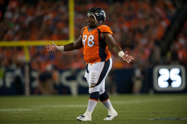 DENVER, CO - AUGUST 07:  Defensive tackle Terrance Knighton #98 of the Denver Broncos talks to teammates during a break in the game against the Seattle Seahawks during preseason action at Sports Authority Field at Mile High on August 7, 2014 in Denver, Colorado.  (Photo by Dustin Bradford/Getty Images)