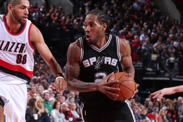 PORTLAND, OR - DECEMBER 15:  Kawhi Leonard #2 of the San Antonio Spurs drives to the basket against the Portland Trail Blazers on December 15, 2014 at the Moda Center Arena in Portland, Oregon. NOTE TO USER: User expressly acknowledges and agrees that, by downloading and or using this photograph, user is consenting to the terms and conditions of the Getty Images License Agreement. Mandatory Copyright Notice: Copyright 2014 NBAE (Photo by Sam Forencich/NBAE via Getty Images)