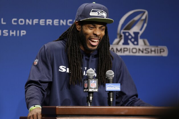 Seattle Seahawks cornerback Richard Sherman laughs as he talks to reporters Wednesday, Jan. 14, 2015, before NFL football practice in Renton, Wash. The Seahawks will face the Green Bay Packers, Sunday in the NFC Championship game. (AP Photo/Ted S. Warren)