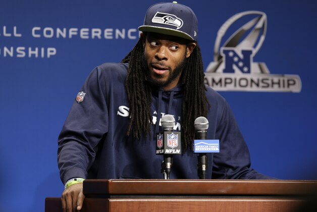 Seattle Seahawks cornerback Richard Sherman talks to reporters Wednesday, Jan. 14, 2015 before NFL football practice in Renton, Wash. The Seahawks will face the Green Bay Packers Sunday in the NFC Championship game. (AP Photo/Ted S. Warren)