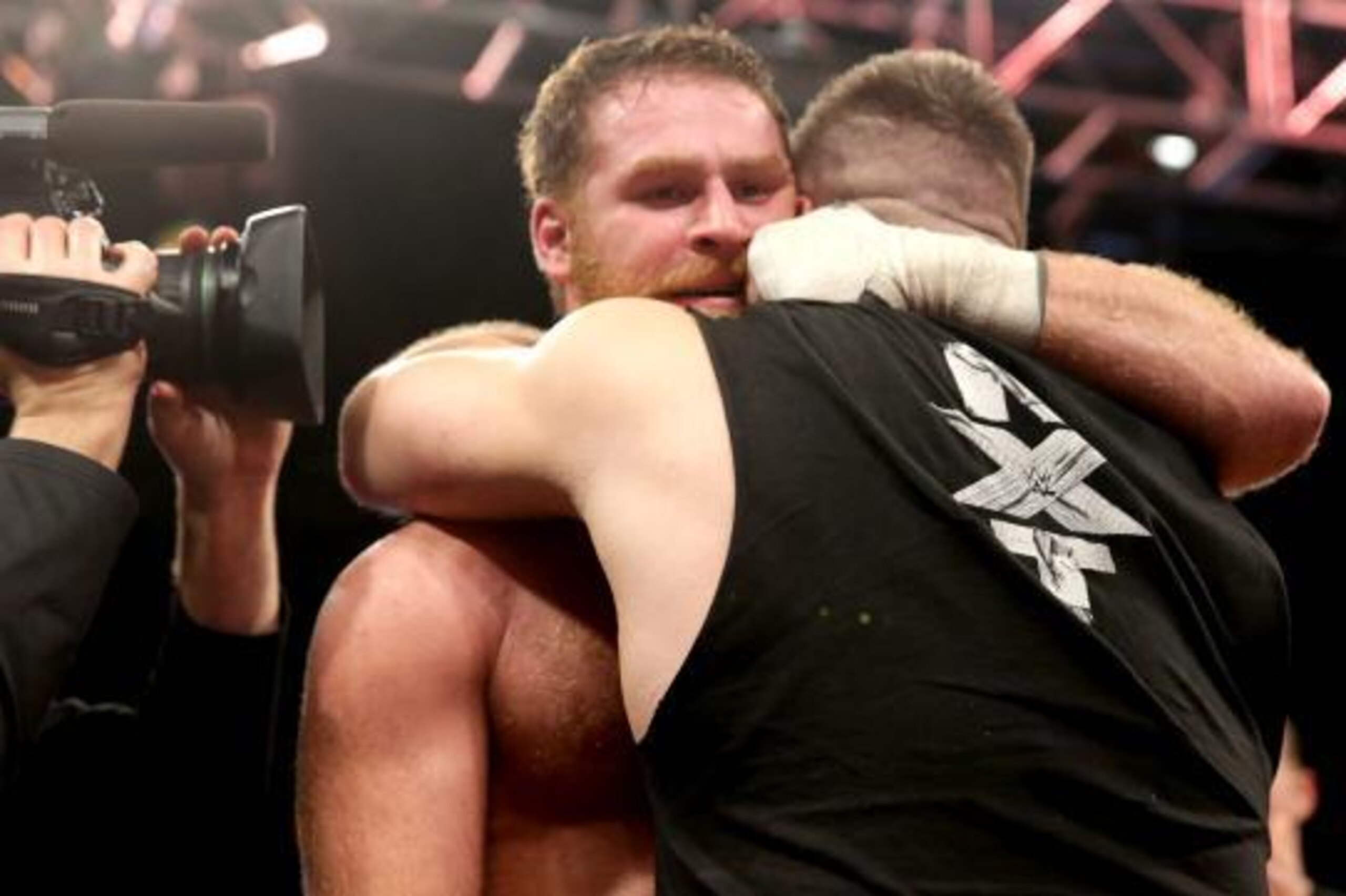 Sami Zayn and Kevin Owens hug before Owens' betrayal.