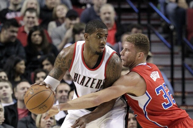 Los Angeles Clippers forward Blake Griffin, right, reaches for the ball held by Portland Trail Blazers forward LaMarcus Aldridge during the first half of an NBA basketball game in Portland, Ore., Wednesday, Jan. 14, 2015.  (AP Photo/Don Ryan)