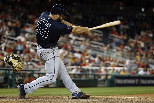 Atlanta Braves' Evan Gattis (24) follows through on a single that scored the go-ahead run against the Washington Nationals during the 13th inning of a baseball game at Nationals Park on Friday, June 20, 2014, in Washington. The Braves won 6-4 in 13 innings. (AP Photo/Alex Brandon)
