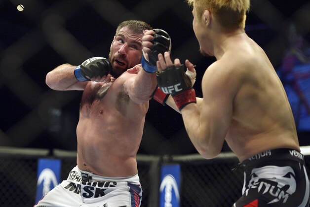 Apr 26, 2014; Baltimore, MD, USA;  Issac Vallie-Flagg (blue gloves) fights against Takanori Gomi (red gloves) during UFC 172 at  Baltimore Arena. Mandatory Credit: Tommy Gilligan-USA TODAY Sports