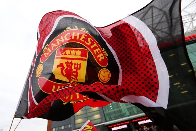 MANCHESTER, ENGLAND - JANUARY 11:  Manchester United flags are displayed for sale outside the stadium before the Barclays Premier League match between Manchester United and Southampton at Old Trafford on January 11, 2015 in Manchester, England.  (Photo by Clive Mason/Getty Images)