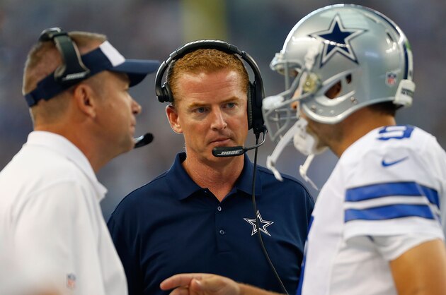 ARLINGTON, TX - OCTOBER 19:  Head coach Jason Garrett of the Dallas Cowboys, center, assistant coach Scott Linehan and Tony Romo #9 of the Dallas Cowboys talk in the first half against the New York Giants at AT&T Stadium on October 19, 2014 in Arlington, Texas.  (Photo by Wesley Hitt/Getty Images)