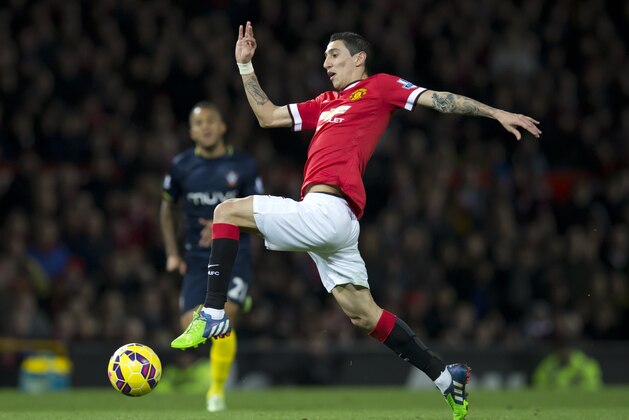 Manchester United's Angel Di Maria takes the ball downfield as Southampton's Ryan Bertrand looks on during the English Premier League soccer match between Manchester United and Southampton at Old Trafford Stadium, Manchester, England, Sunday Jan. 11, 2015. (AP Photo/Jon Super)