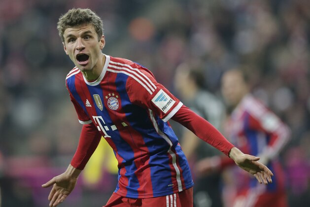 Bayern's Thomas Mueller talks to teammate Arjen Robben from the Netherlands during the German first division Bundesliga soccer match between FC Bayern and SC Freiburg in the Allianz Arena in Munich, Germany, on Tuesday, Dec. 16, 2014. (AP Photo/Matthias Schrader)