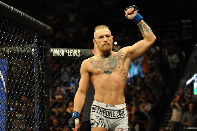 Sep 27, 2014; Las Vegas, NV, USA; Conor McGregor enters the octagon ready for a featherweight fight against Dustin Poirier during UFC 178 at MGM Grand Garden Arena. Mandatory Credit: Stephen R. Sylvanie-USA TODAY Sports