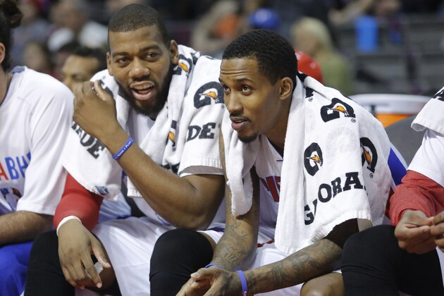 Detroit Pistons center Greg Monroe (10) chats with Detroit Pistons guard Brandon Jennings (7) while sitting on the bench during the first half of an NBA basketball game against the Brooklyn Nets Friday, Feb. 7, 2014, in Auburn Hills, Mich. (AP Photo/Duane Burleson)