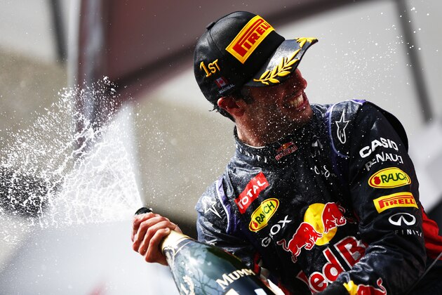 MONTREAL, QC - JUNE 08:  Racewinner Daniel Ricciardo of Australia and Infiniti Red Bull Racing is sprayed with champagne by teammate Sebastian Vettel of Germany and Infiniti Red Bull Racing following his victory during the Canadian Formula One Grand Prix at Circuit Gilles Villeneuve on June 8, 2014 in Montreal, Canada.  (Photo by Andrew Hone/Getty Images)