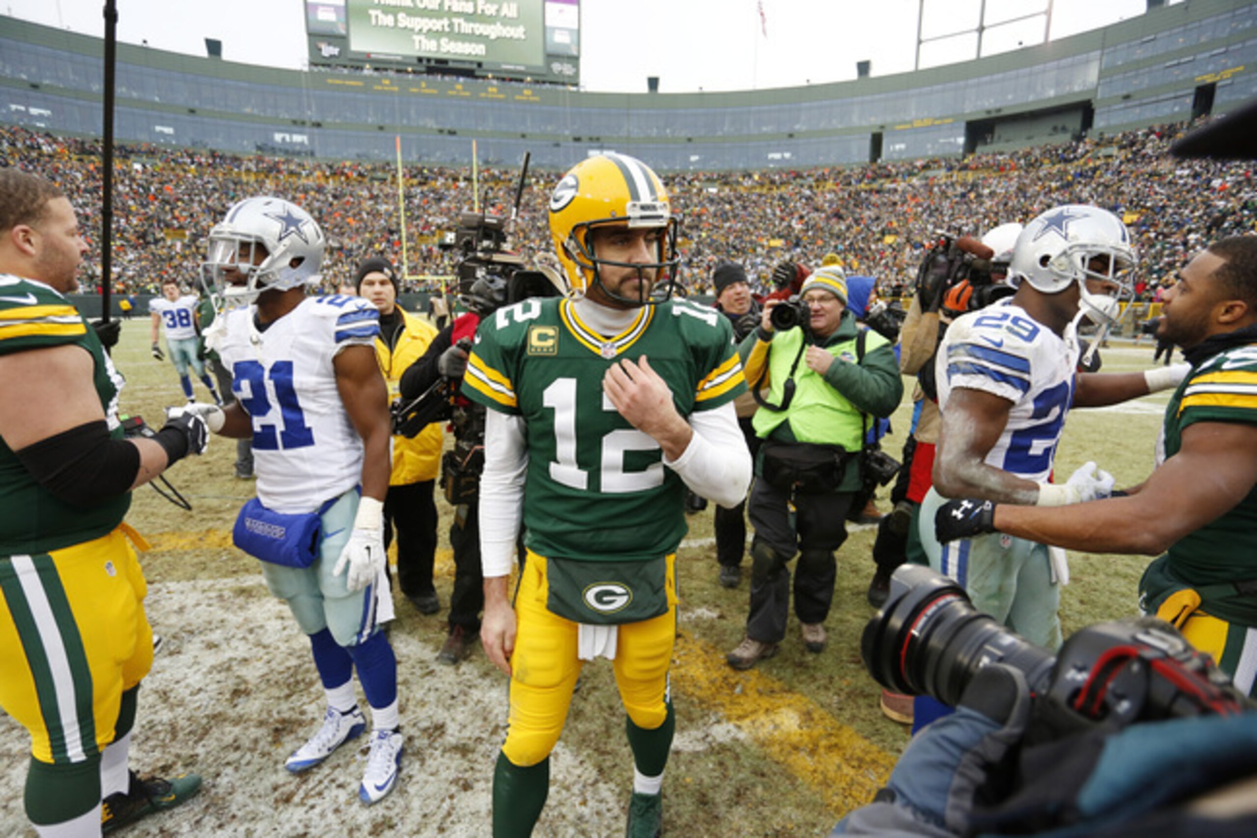 Green Bay Packers quarterback Aaron Rodgers (12) walks on the field after an NFL divisional playoff football game against the Dallas Cowboys Sunday, Jan. 11, 2015, in Green Bay, Wis. The Packers won 26-21. (AP Photo/Matt Ludtke)