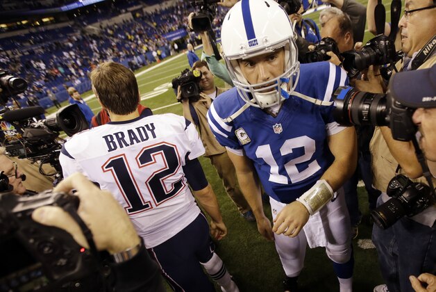 Indianapolis Colts quarterback Andrew Luck, right, walks away from greeting New England Patriots quarterback Tom Brady following an NFL football game in Indianapolis, Sunday, Nov. 16, 2014. The Patriots defeated the Colts 42-20.  (AP Photo/AJ Mast)
