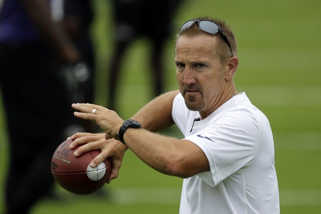 Baltimore Ravens assistant head coach Steve Spagnuolo throws a pass during a training camp practice, Thursday, July 24, 2014, at the team's practice facility in Owings Mills, Md. (AP Photo)
