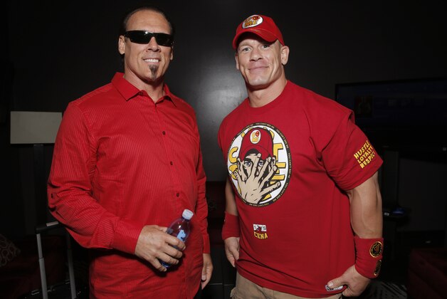 WWE 2K15 cover Superstar John Cena (right) meets with Sting backstage at the SummerSlam Confidential Panel on at Club Nokia, on Saturday, August 16, 2014 in Los Angeles. (Photo by Todd Williamson/Invision for 2K/AP Images)