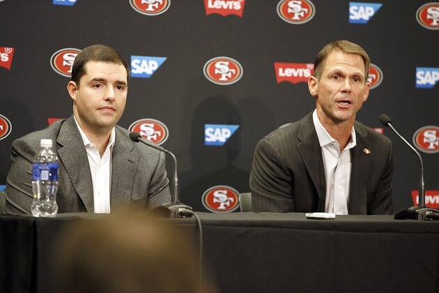 San Francisco 49ers owner Jed York, left, looks on as general manager Trent Baalke, right, speaks during a news conference at 49ers football headquarters in Santa Clara, Calif., on Monday, Dec. 29, 2014. (AP Photo/Tony Avelar)