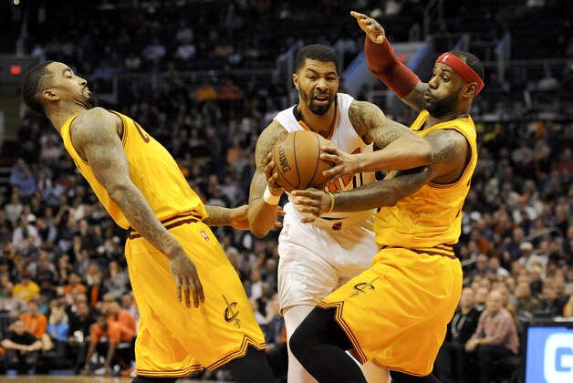 Jan 13, 2015; Phoenix, AZ, USA; Phoenix Suns forward Markieff Morris (11) drives to the basket in between Cleveland Cavaliers guard J.R. Smith (5) and forward LeBron James (23) during the fourth quarter at US Airways Center. Phoenix won 107-100. Mandatory Credit: Casey Sapio-USA TODAY Sports